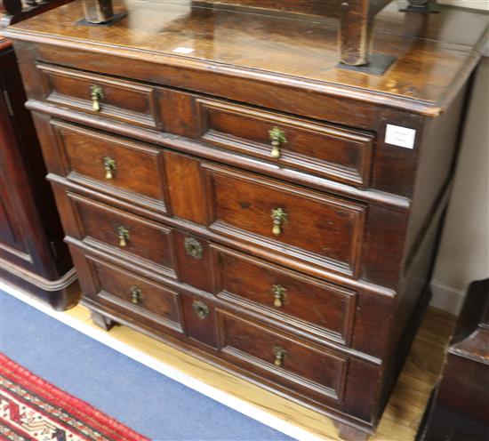 A 17th century style oak chest, fitted four long block fronted drawers W.96cm
